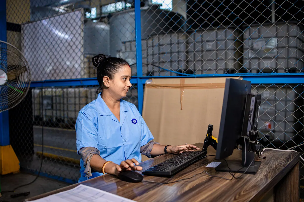 An operator at a desktop computer in a plant office